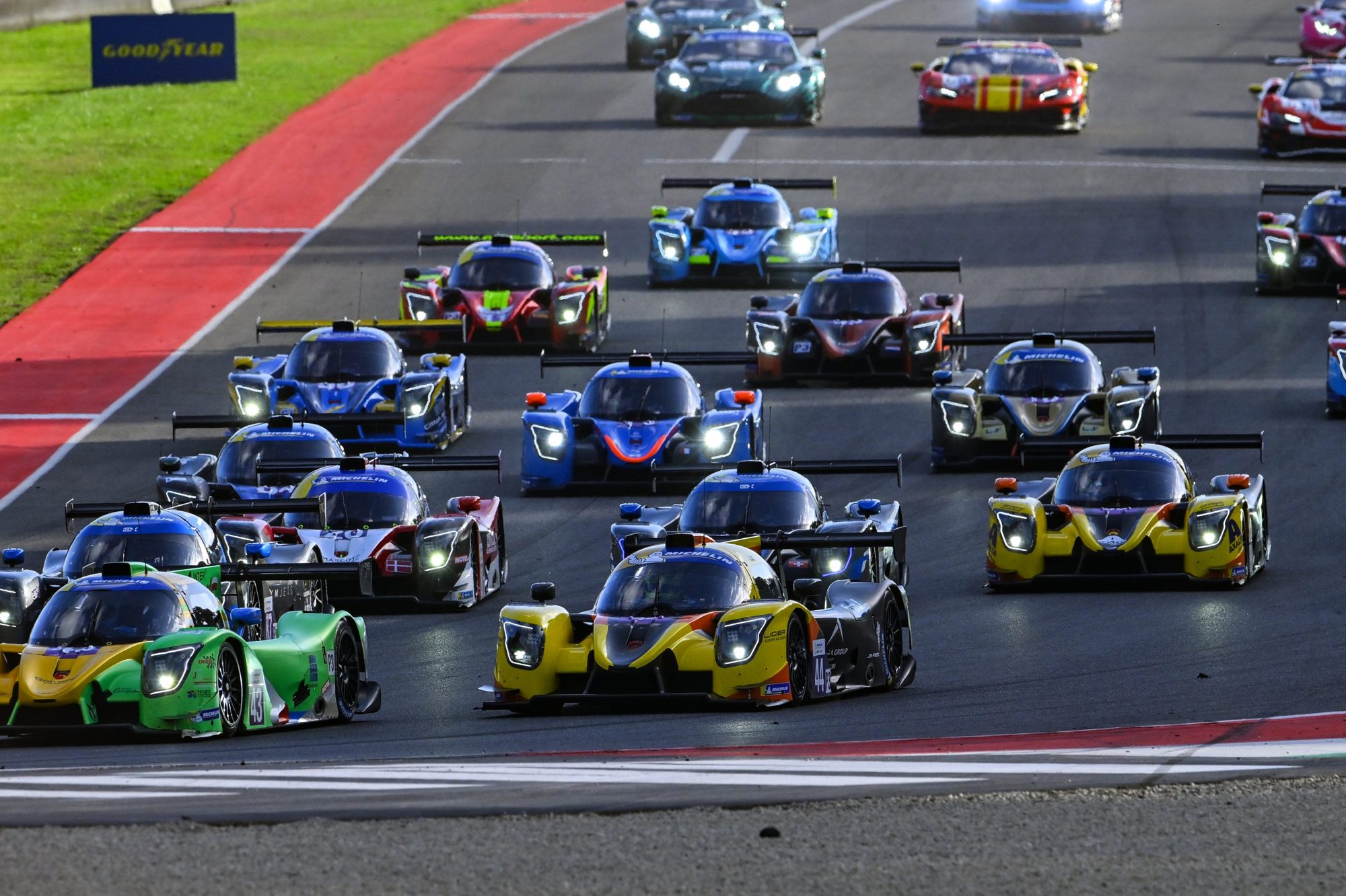 A grid of LMP3 prototypes heading into the first corner